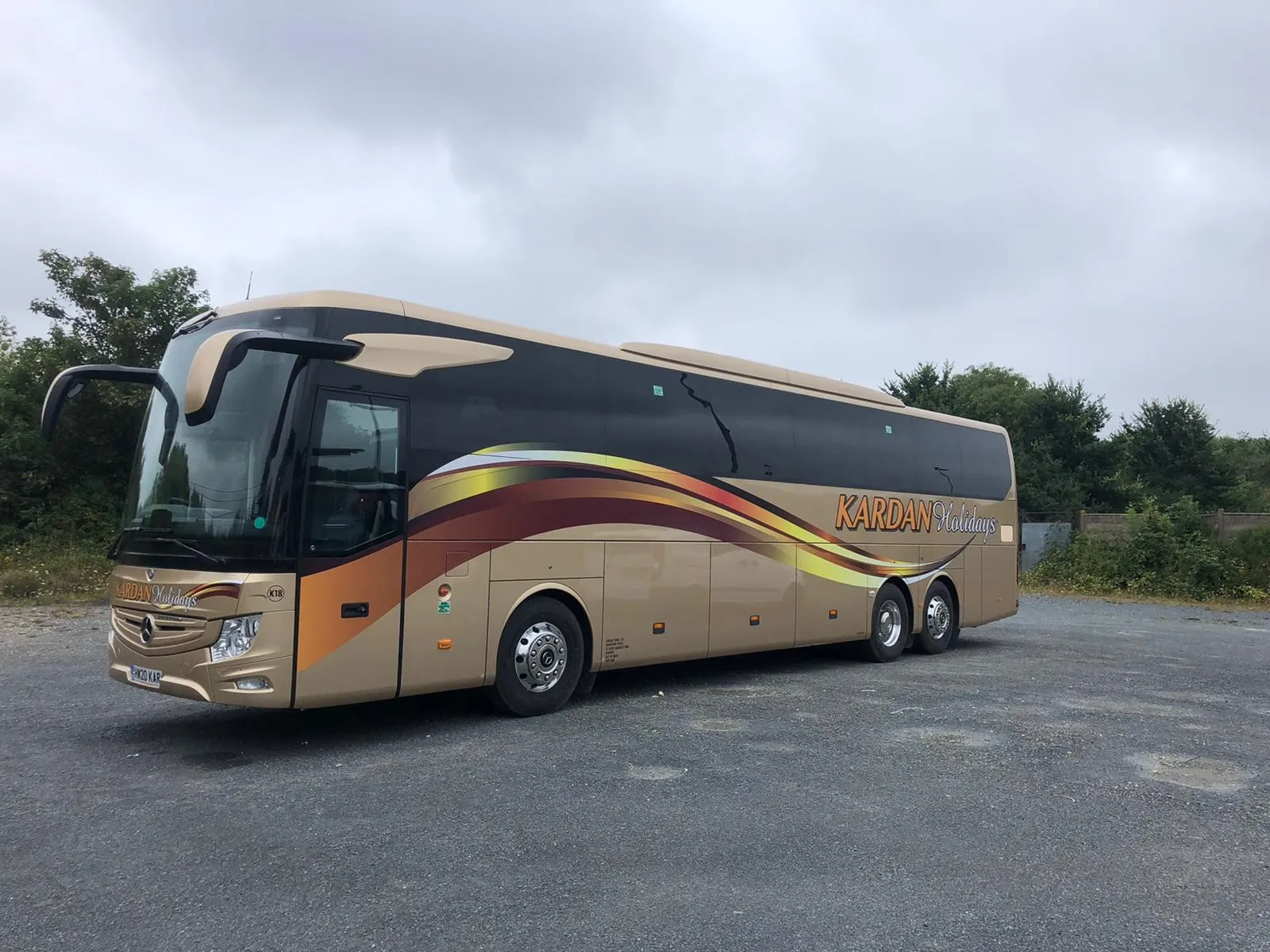 A Kardan Travel Mercedes coach in gold livery